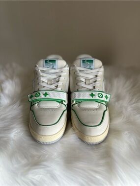 Louis Vuitton men's white & green low-top sneakers with monogram strap.
